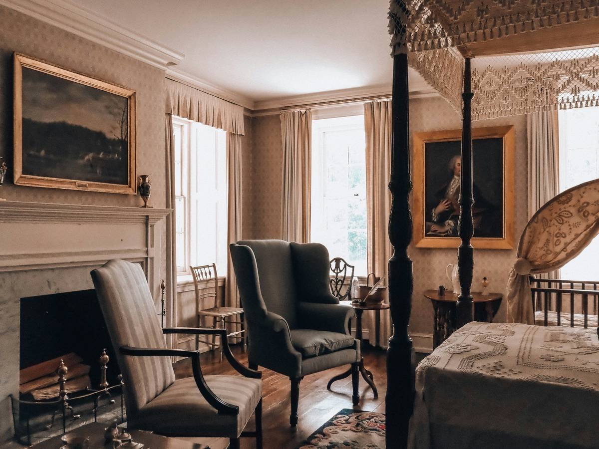 Side-by-side comparison: cluttered canopy bed with heavy drapes vs. minimalist canopy with sheer linen and ample breathing room